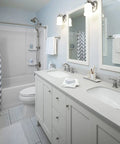 Bathroom with Bancroft Single Sconce with Frosted Glass Shade, brushed nickel finish, above double sinks, sleek modern design.