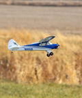 Sport Cub S 2 RC Airplane BNF Basic with Safe Technology flying in a grassy field