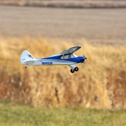 Sport Cub S 2 RC Airplane BNF Basic with Safe Technology flying in a grassy field