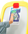 Child drawing on paper attached to Mega Size Magnetic Double Sided Kids Easel Built Tough For Endless Creative Sessions.