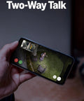 Person using phone to view Floodlight Pro Security Camera With Retinal 2K Video Color Night Vision Two Way Talk And Audio 3D Motion Detection Built In 110 dB Siren Perfect For Home Or Biz Outdoor Security.