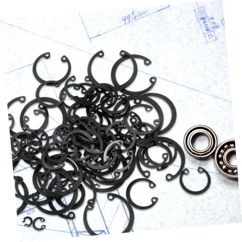 Elastic Circlip Bearing Clips Set Assorted Retaining Rings Kit with Metal Snap Rings and Bearings on a Blueprint