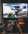 Person using FrSky D16 LiteRadio 2 SE Transmitter For FPV Drones, USB C Charging, for simulator on a screen.