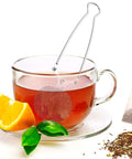 Glass teacup with Stainless Steel Tea Infuser Ball Strainer With Handle 3 Pack Ultra Fine Mesh Filter, orange slice, and tea leaves