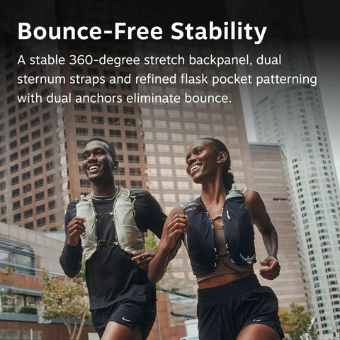 Two runners wearing Dyna LT Womens Running Hydration Vest With Hydraulics Soft Flasks, Black Medium, in urban setting