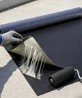 Real Deal Self Adhesive EPDM Rubber Roofing Membrane For Flat Roofs 53 Mil Thick being applied with a roller.