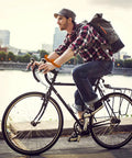 Cyclist wearing 24 Piece Bicycle Theme Motivational Silicone Wristbands Set For Parties BMX Vibes riding by the river.