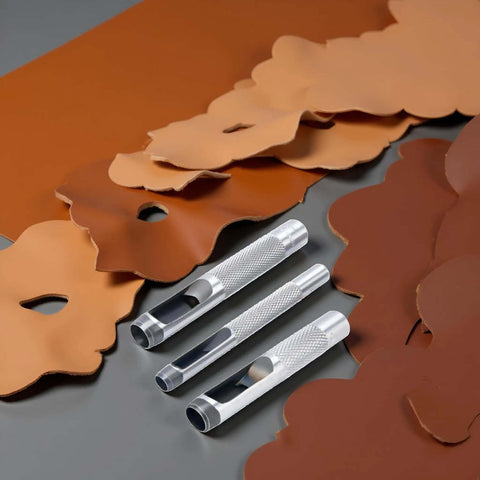 Pro Grade Leather Punch Set With Steel Hollow Punches, Three Piece Grommet Hole Punch Kit, tools on brown leather sheets