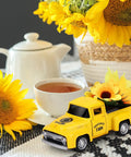 Sunflower Metal Farm Truck Decor Set Of Four With Large And Mini Sunflowers Vintage Diecast Style Pickup on table with tea set