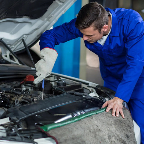 Man in blue coverall using Hella Tough Dual End Metal Scribe Set With Straight Hook And Angled Picks for precise marking in automotive engine.