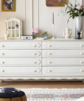 Dresser featuring Six Pack White Dresser Knobs Set Featuring Pearl Clover Design With Gold Finish in a bright room.