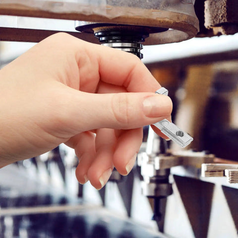 Hand holding Slick Heavy Duty 2020 Series L Shaped Corner Brackets for precision joinery in CNC router assembly.