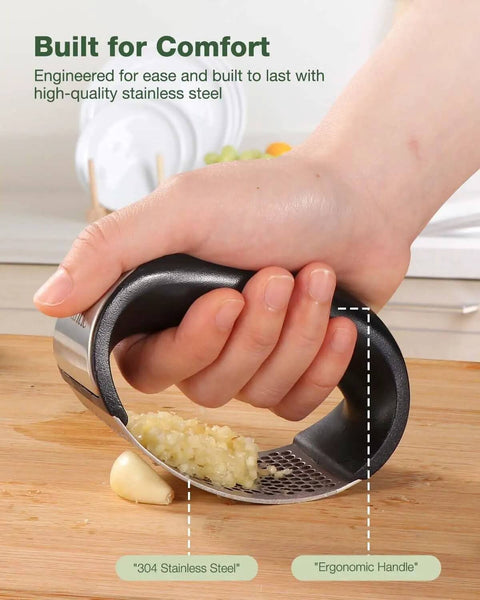 Hand using Garlic Press Rocker Stainless Steel Crusher Mincer and Chopper with Peeler and Scraper for effortless garlic crushing