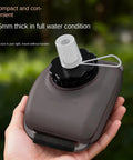 Hand holding a 200ml Wrist Water Bottle On The Go 200ml Leak Proof No Spill Hydration Gear With Silicone Strap showing mouthpiece.