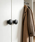 Knockout Matte Black Bifold Closet Door Knobs Featuring Round Cabinet Pulls Durable Aluminum Alloy Build complete set on wardrobe.