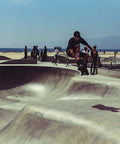 Skater jumps in park using 52mm skateboard wheels with bearings and preinstalled spacers 90A black polyurethane pack of 4.