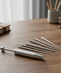 6 Piece Piercing Ball Grabber Kit Pro Grade Stainless Steel Piercing Tools for Easy Jewelry Changes on a wooden table.