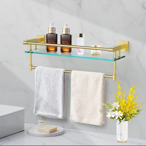 Pro Grade 20 Inch Wall Mount Glass Shelf With Towel Rack In Brushed Gold Finish displaying toiletries and towels in bathroom setting.