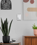 Manual 4 Wire Line Voltage Baseboard Thermostat For Electric Heaters No Frills mounted on wall near decor