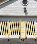 Rock Solid Rolling Security Gate 17ft Expandable Metal Barricade Heavy Duty Outdoor Fence with yellow locking wheels in position.