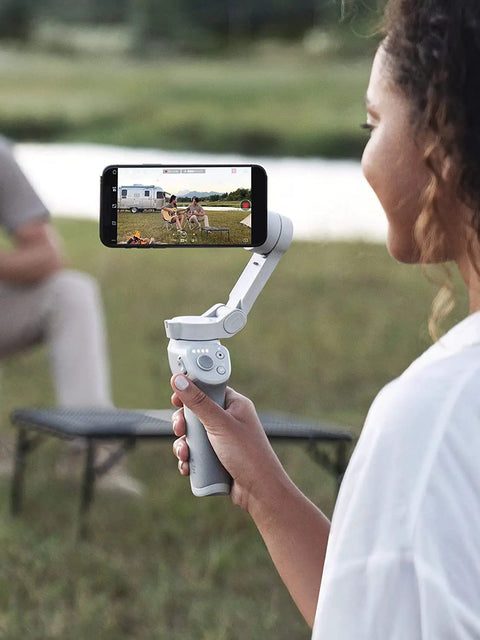 Person using Next Level Smartphone Gimbal Stabilizer With Tripod Magnetic Quick Attach Design Portable Foldable Body for filming outdoors
