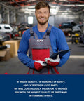Mechanic holding clipboard in auto repair workshop, wearing blue and red uniform with logo visible.