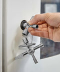 Hand using TwinKey Multifunctional Spanner Kit With Magnetic Eight Arm Two By Four Way Spider Keys for shut-off system operation.