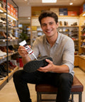 Man holding a shoe and a tube of All Purpose Quick Dry Shoe Glue For Sneakers Boots And Sandals, Clear Flexible Bonding Sealant.