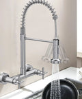 Rock Solid Wall Mount Kitchen Faucet With Smooth Dual Handles And No Fuss Two Function Spray For Laundry Or Commercial Sinks Built Tough From Lead Free Brushed Nickel Stainless Steel in use with pot under spray
