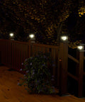 Go-To LED Post Cap Lights For Outdoor Wood Fence And Decks Fits 3.5 By 3.5 4 By 4 4.5 By 4.5 And 5 By 5 Posts glowing on fence at night