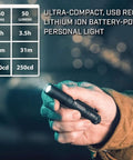 Person holding MicroStream USB 250 Lumen EDC LED Flashlight With Rechargeable Battery Red, ultra-compact, in dim light