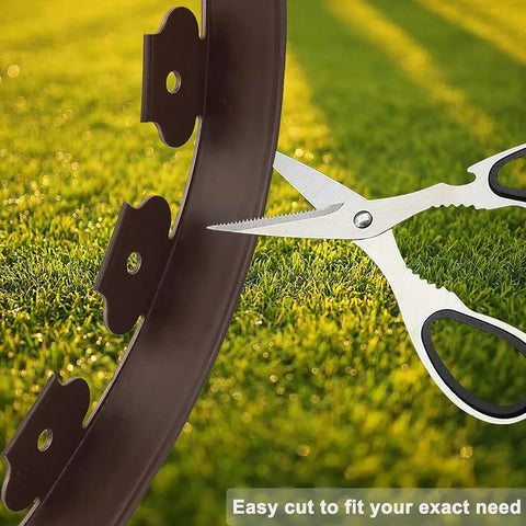 Scissors cutting 40 Ft Brown Landscape Edging Kit With 40 Spiral Stakes, No Dig Plastic Border Roll on grass