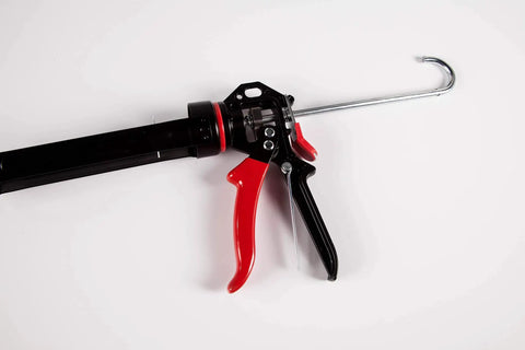 Extreme Duty 9 Inch Caulk Gun Workhorse With 26 To 1 Thrust Ratio And 950 Lb Force, featuring revolving barrel and ergonomic grip.