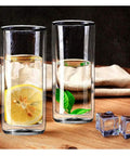 Heavy Duty Double Wall Insulated Borosilicate Glass Tumblers Set Of 2 20 Oz Highball Cups for iced tea with lemon and mint leaves.