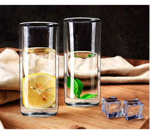 Heavy Duty Double Wall Insulated Borosilicate Glass Tumblers Set Of 2 20 Oz Highball Cups for iced tea with lemon and mint leaves.