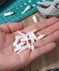 40 Pack Spring Loaded Shutter Repair Pins with Dual Sizes on hand, plastic fasteners for blinds and cabinet hinges.