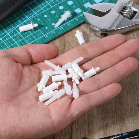 40 Pack Spring Loaded Shutter Repair Pins with Dual Sizes on hand, plastic fasteners for blinds and cabinet hinges.