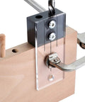 Rock Solid One Quarter Inch Dowel Drilling Jig Kit With Hardened Steel Bore Guides And Clear Acrylic Base showing dowel alignment on wood.