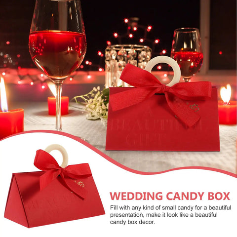 Valentine Day Candy Boxes With Handles Pack Of 20 Portable Paper Wrapping Boxes for parties, adorned with a red bow on table.