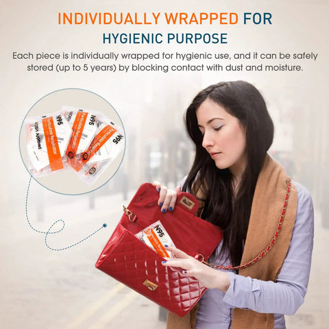 Woman placing Premium NIOSH Approved N95 Respirator Masks 100 Pack in purse, highlighting individual wrapping for hygiene.