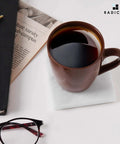 Solid White Square Marble Coasters Set Of Six, Polished Drink Pads For Dining Tables And Coffee Bars, Legit Natural Stone Home Accessories With Modern Minimalist Vibes with coffee cup on coaster.