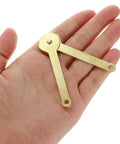 Gold Metal Lid Stay Hinge 2.7x0.3 Inches held in hand, showing compact size and gold finish, from Six Pack Durable Rust Resistant Lid Support Hinge series