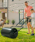 Father and son using Lawn Roller For Seed And Sod Preparation With 10 Gallon Water Fill Capacity And Welded Steel Drum Construction
