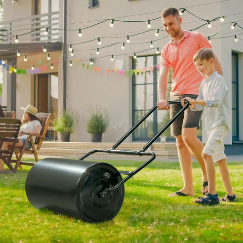 Heavy Duty Push Lawn Roller With 16 Inch Steel Drum Black Finish Rugged Rust Resistant Steel being used in a backyard