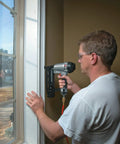 Person using 16-Gauge Straight Finish Nailer Kit With Tool-Free Depth-Of-Drive Adjustment on a window frame