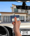 Hand holding Navy Blue Universal Garage Door Opener Remote For LiftMaster 971LM 390MHz inside car, facing garage