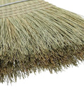 Close-up of the bristles of a 42 Inch Natural Fiber Wire Banded Warehouse Broom With Real Wood Handle For Sweeping Concrete Driveways Garages And Kitchens Built Tough To Handle The Daily Grind.