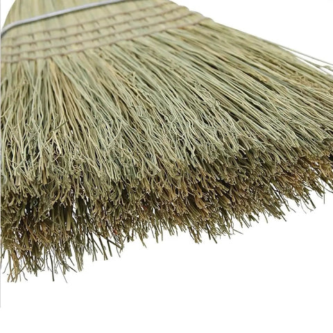 Close-up of the bristles of a 42 Inch Natural Fiber Wire Banded Warehouse Broom With Real Wood Handle For Sweeping Concrete Driveways Garages And Kitchens Built Tough To Handle The Daily Grind.