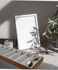 Slick Wooden Sunglasses Display Plate Featuring Seven Grid Slots For Eyeglasses Organization on a neutral surface with glasses.