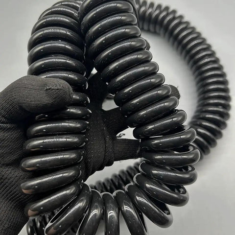 Heavy Duty Flexible Coiled Extension Cord Featuring A Rock Solid Spiral Build That Expands To Sixty Feet, shown in close-up.